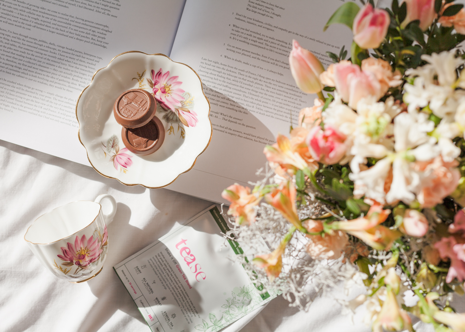tea cup, cookies, and flowers